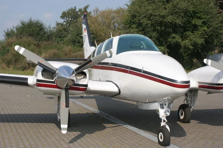 Beechcraft Baron aircraft parked on an apron