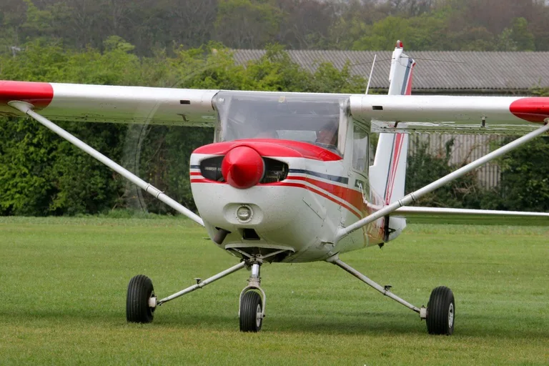 Cessna 152 aircraft on a grass airfield