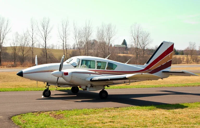 Piper Aztec twin-engine aircraft parked on an apron