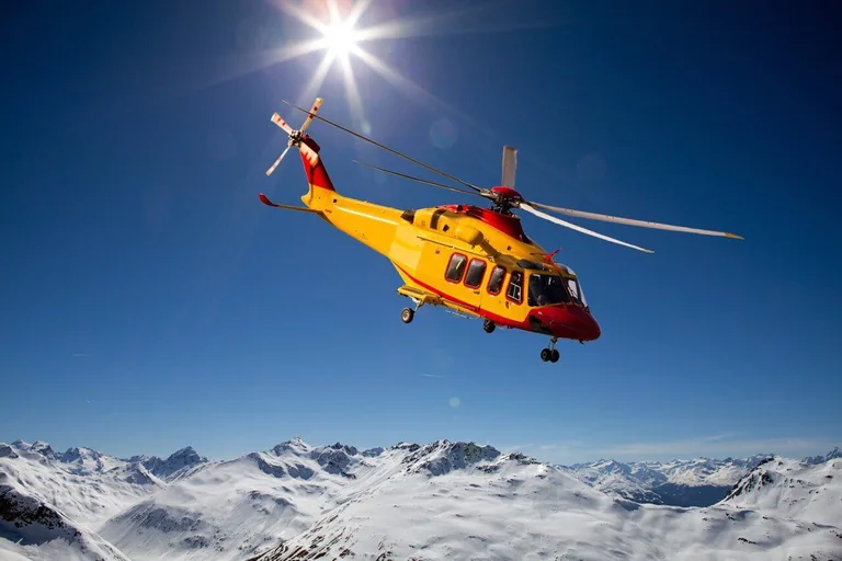 AgustaWestland AW139 helicopter above snowy mountains