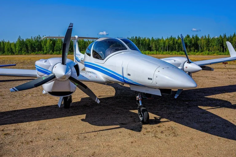 Diamond DA42 twin-engine aircraft parked on an apron