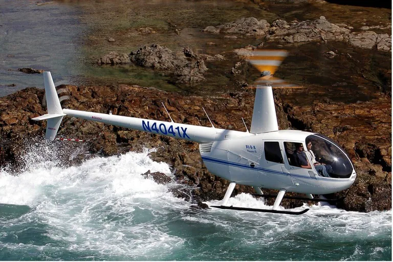 A Robinson helicopter in flight