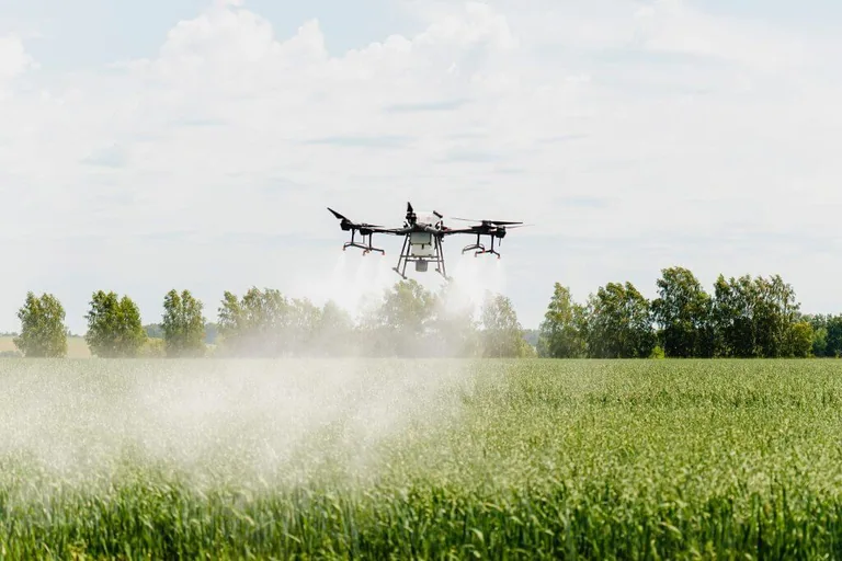 An agricultural drone flying above a cultivated field