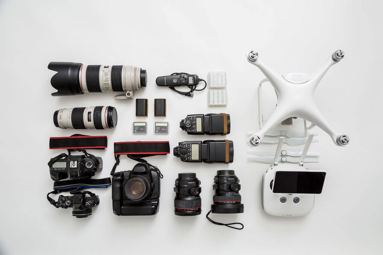 Drone, controller, cameras and detachable photography equipment arranged on a table
