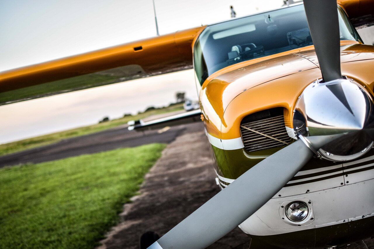Close view of a parked airplane propeller and nose