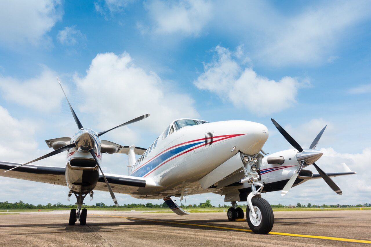 Twin engine airplane parked on an airport apron