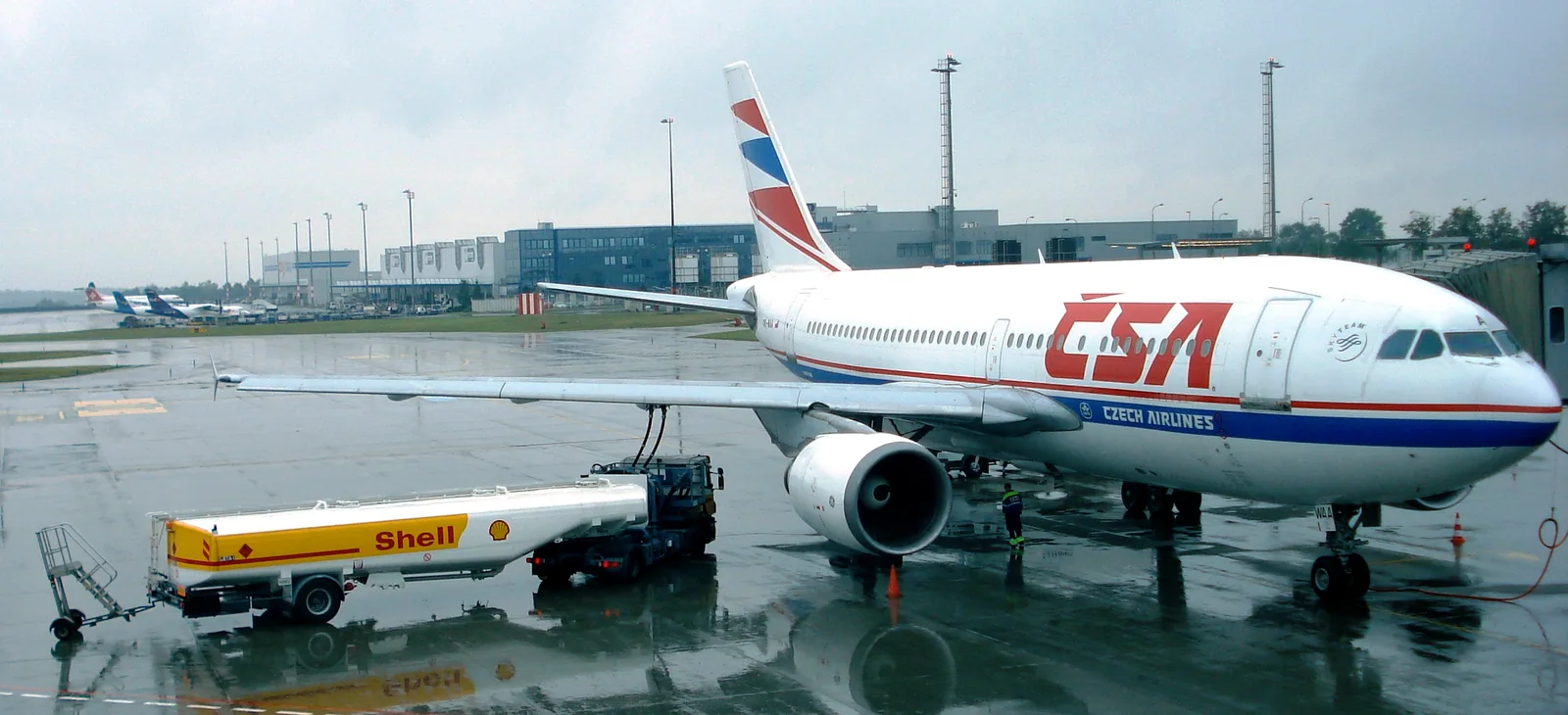 Fuel tanker and hoses beside a Czech Airlines Airbus A310 on the apron at Prague Airport