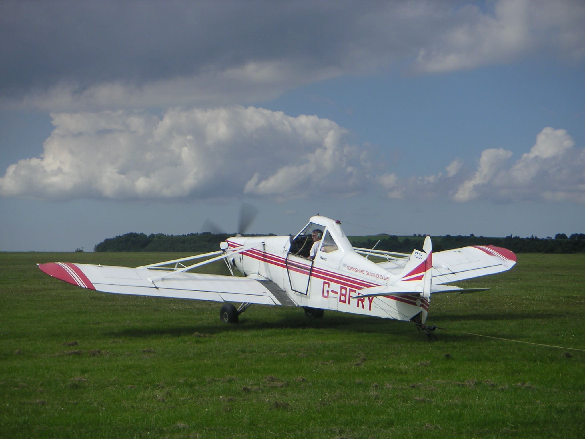 Piper Pawnee G-BFRY on grass at Yorkshire Gliding Club with tow line visible