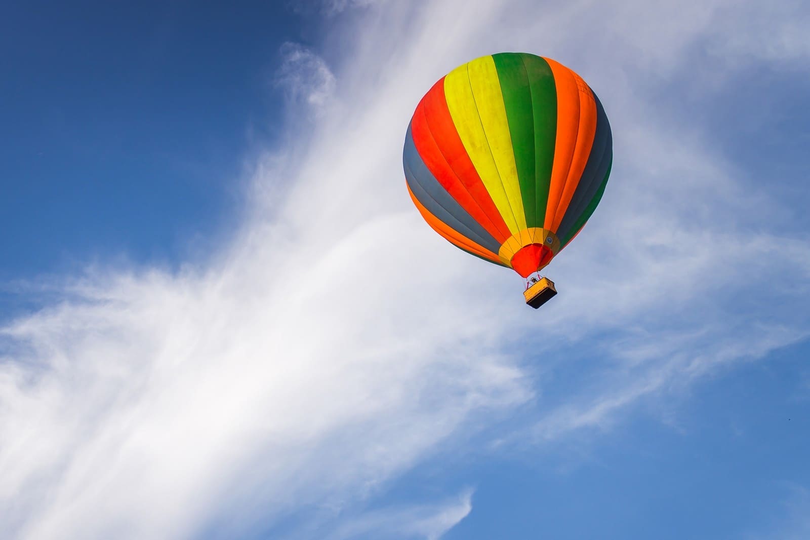 Hot air balloon with basket in flight above Tambov
