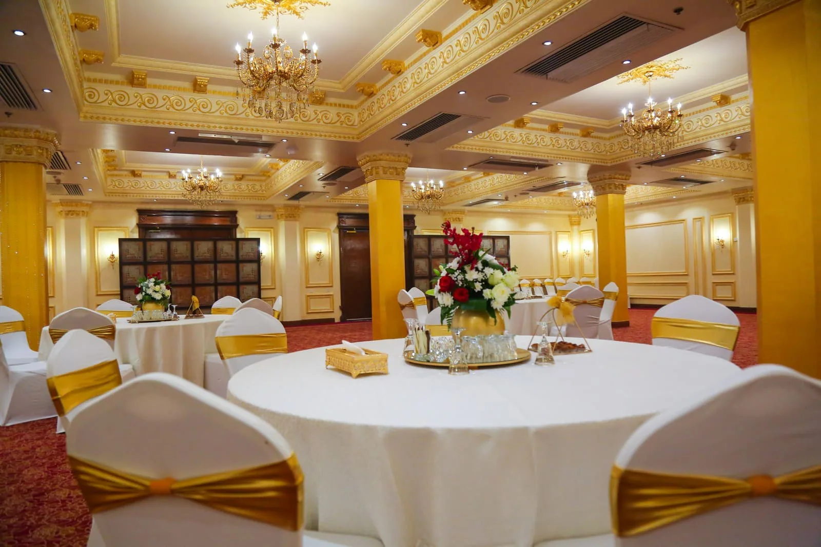 Decorated indoor wedding hall with tables and seating