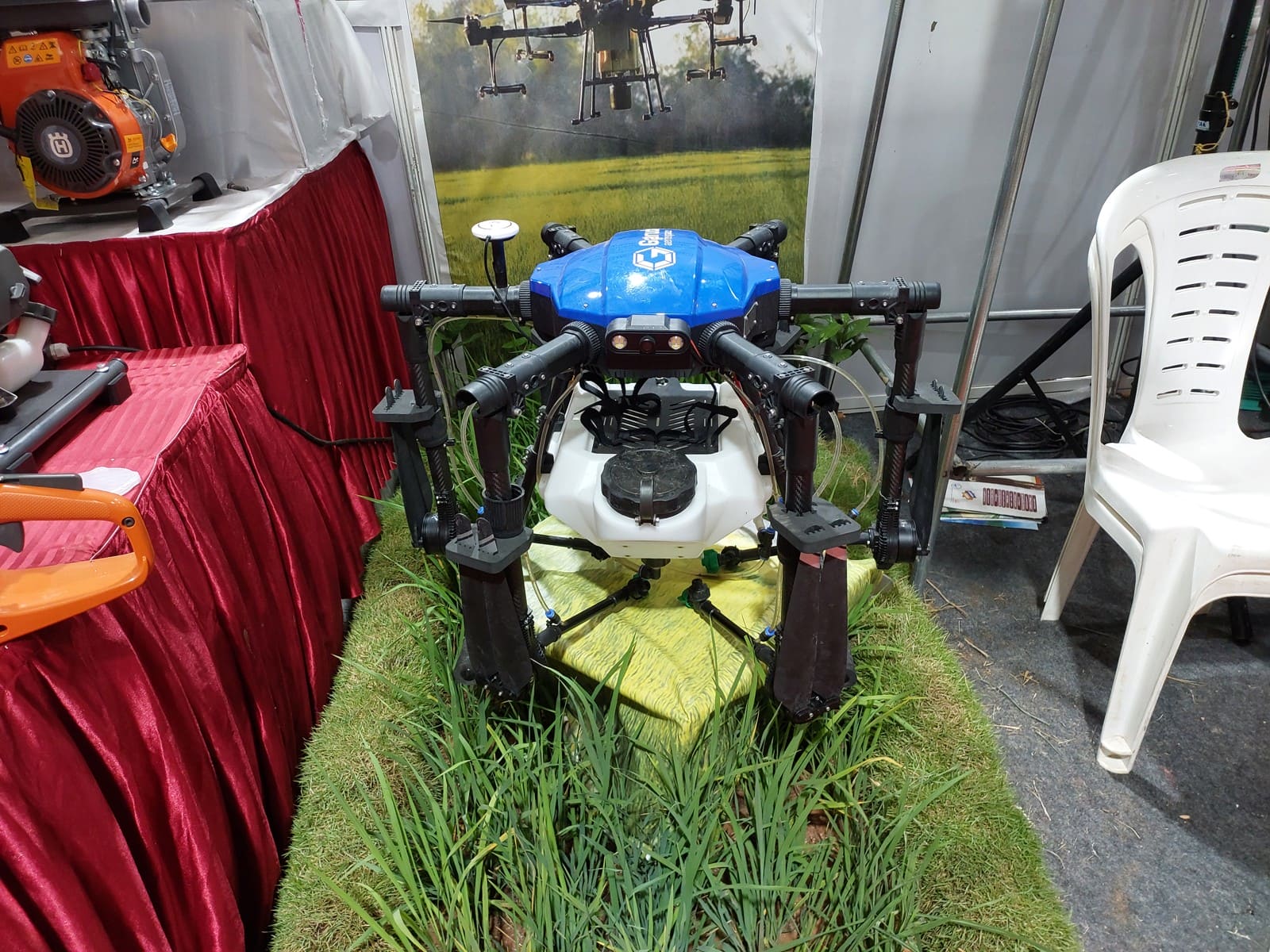 Agricultural spray drone with a tank displayed at an exhibition