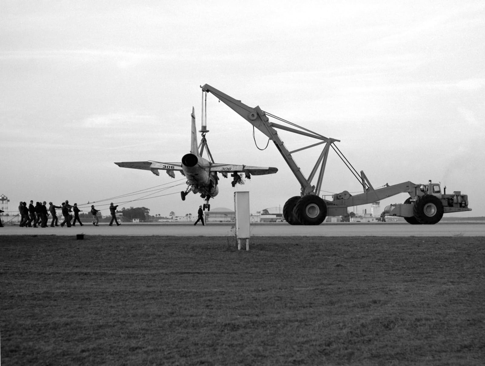 Historical military crane lifting an aircraft