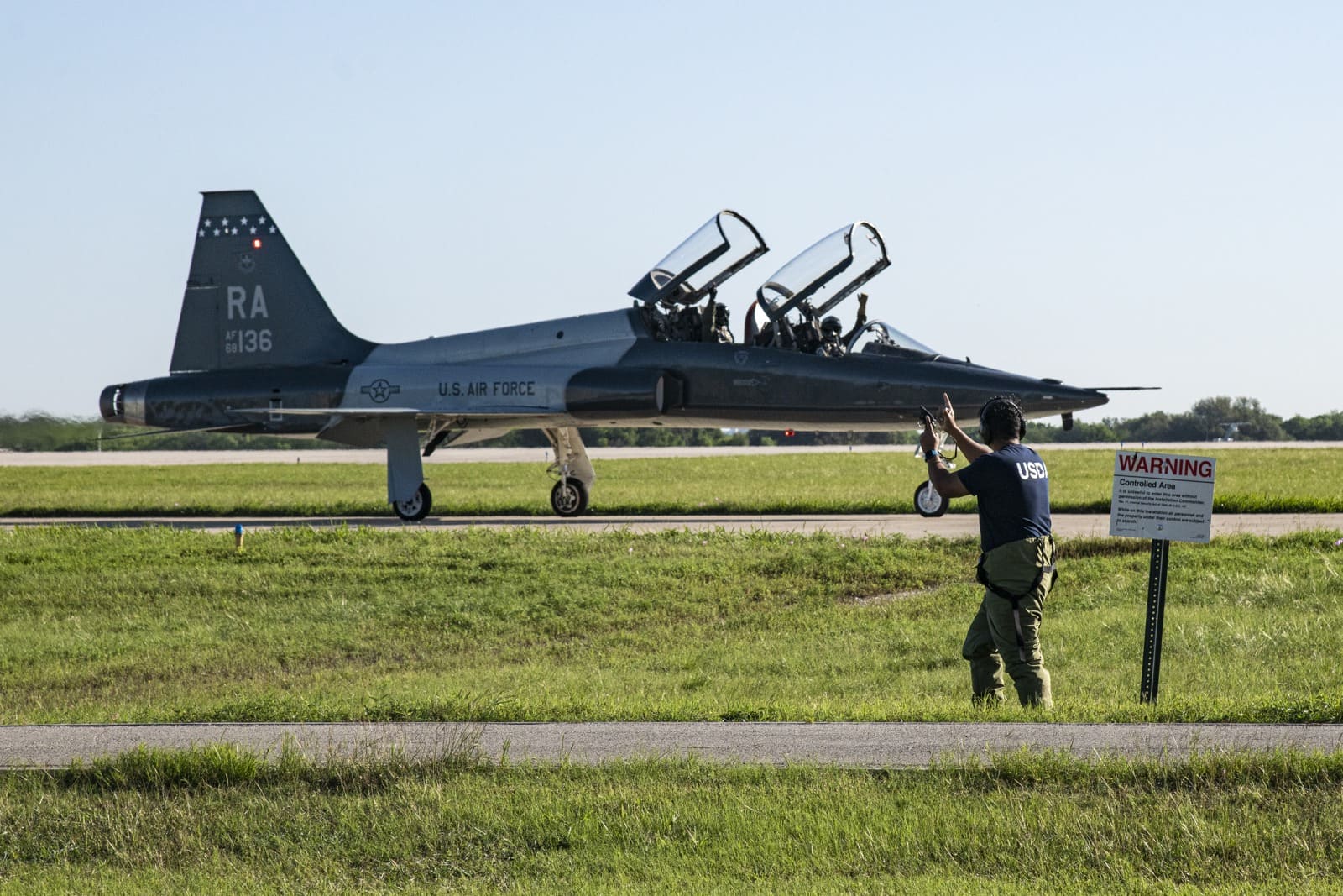 USDA wildlife specialist near a military aircraft