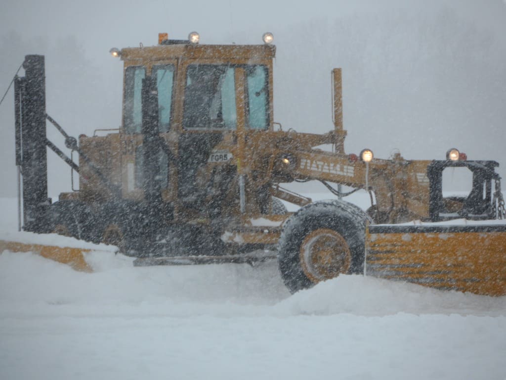 Airport snow removal machine in snowfall