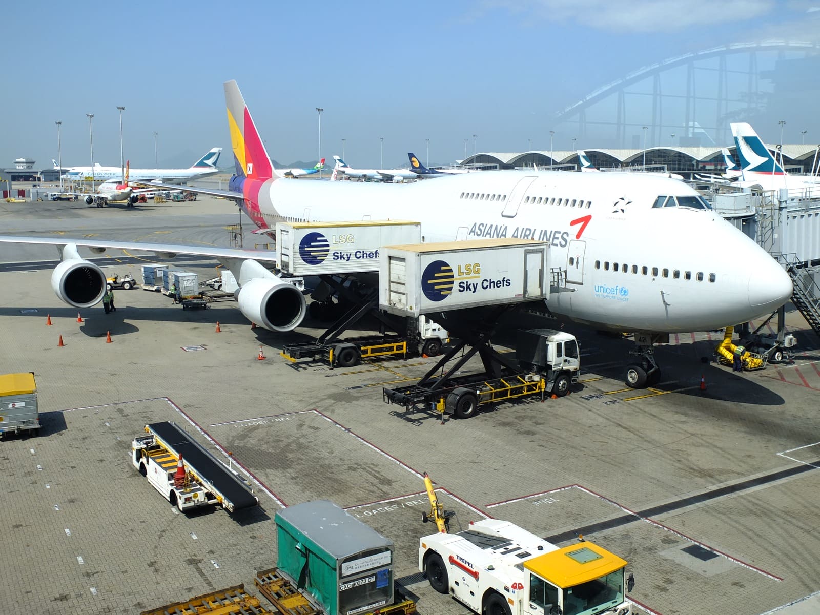 Aircraft catering trucks beside a passenger aircraft in 2014