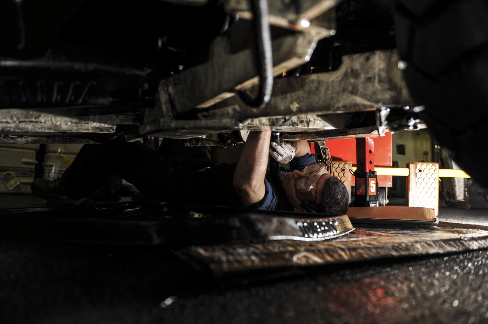 Technician repairing a tow tractor aboard USS Nimitz in 2013