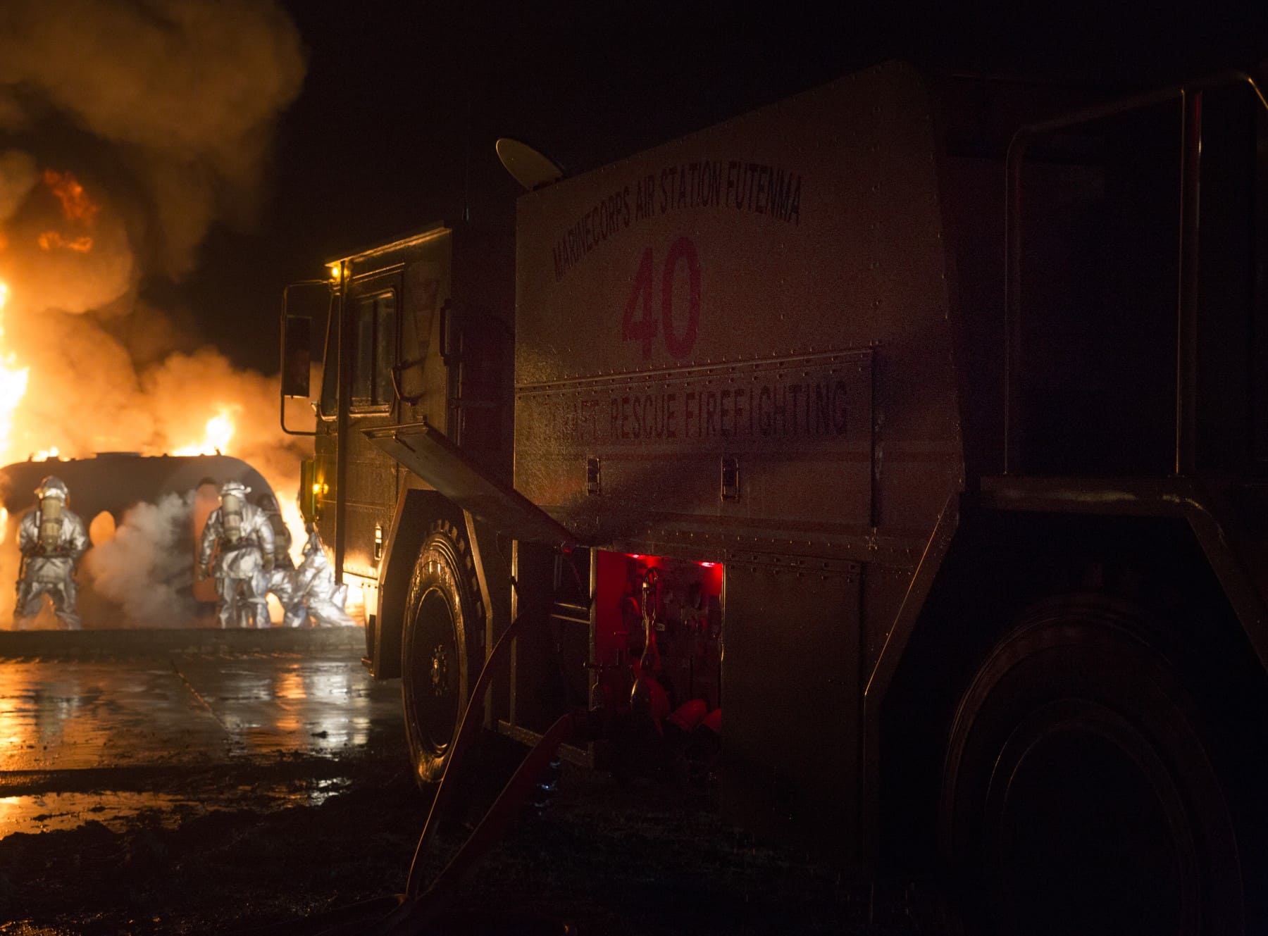 US Marine Corps fire truck beside an aircraft rescue firefighting training pit in 2016