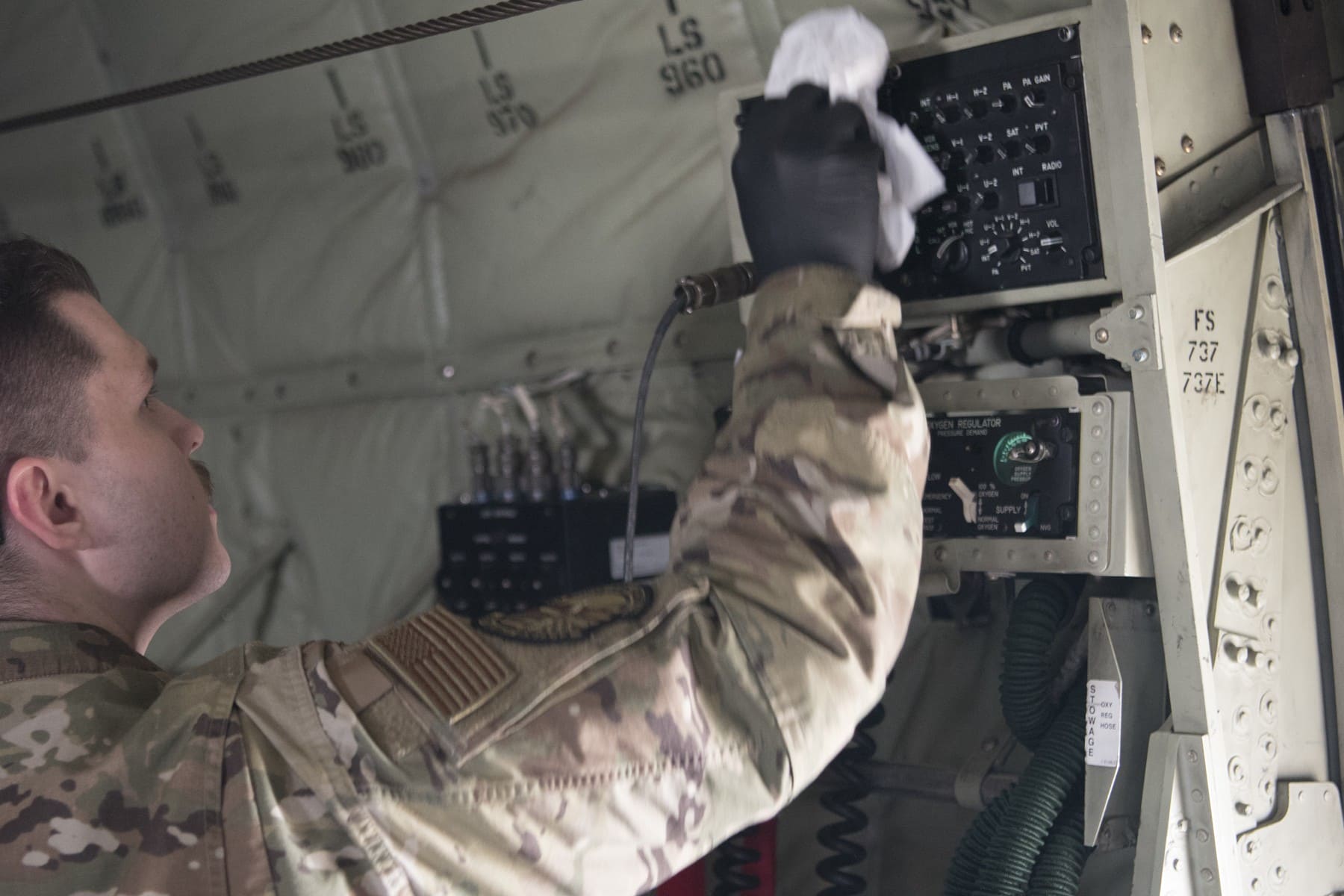 US Air Force crew member wiping a C130J aircraft interior in April2020