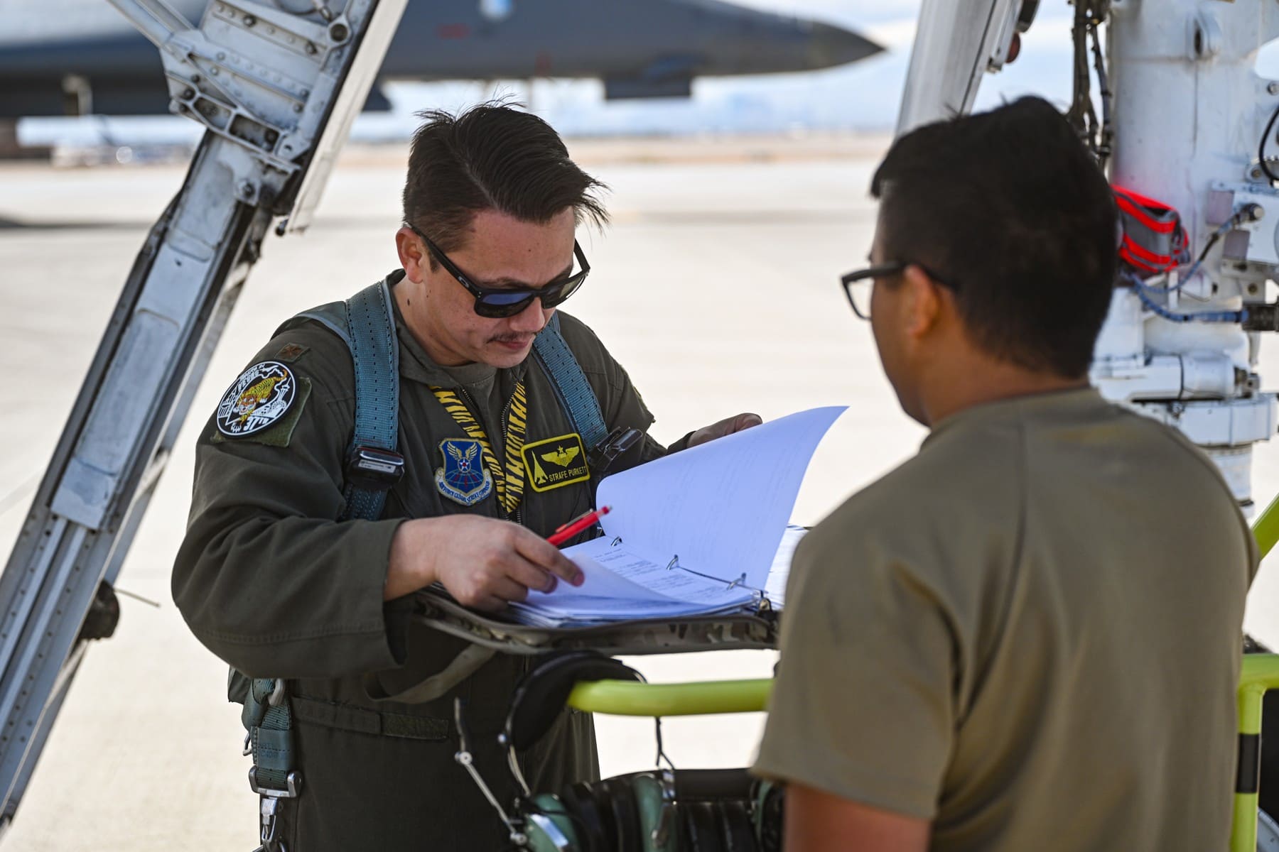 US Air Force personnel reviewing aircraft paperwork at Nellis in March2023
