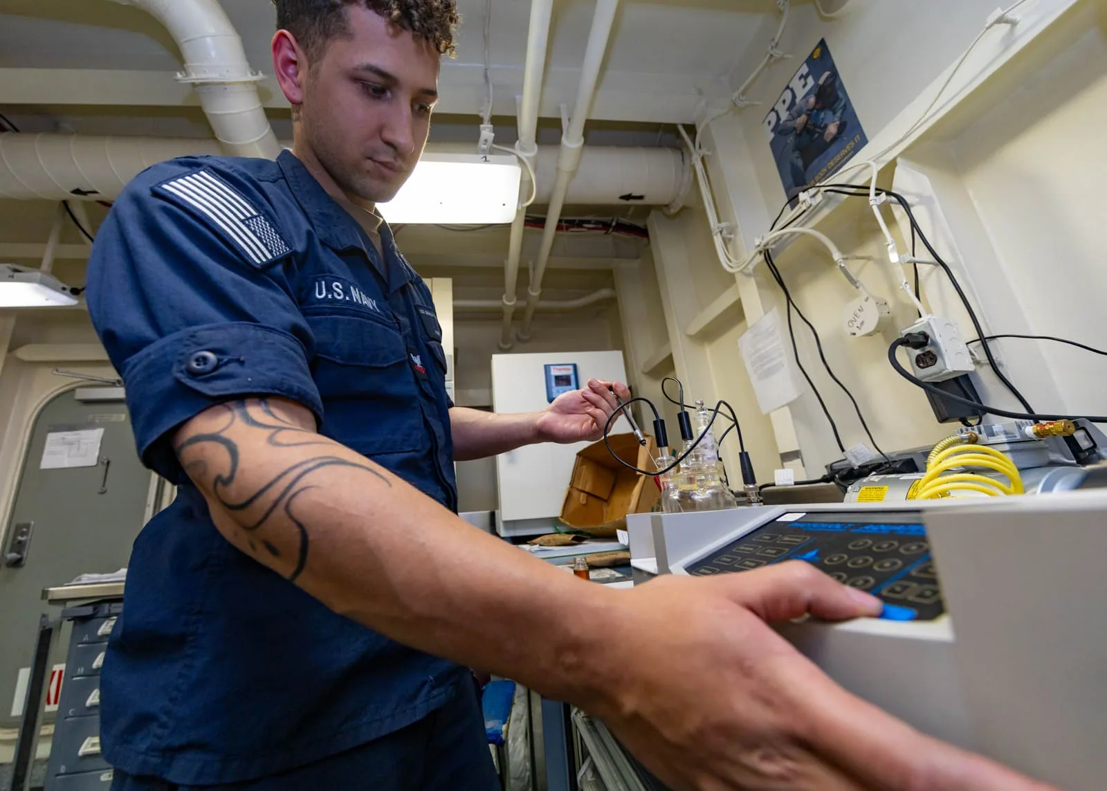 US Navy sailor testing oil samples in 2025