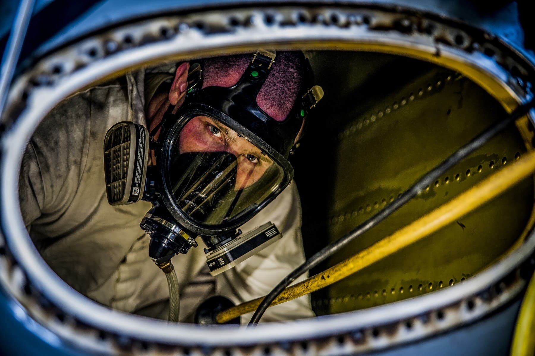 Air Force airman in aircraft fuel tank during historical training exercise in March 2013