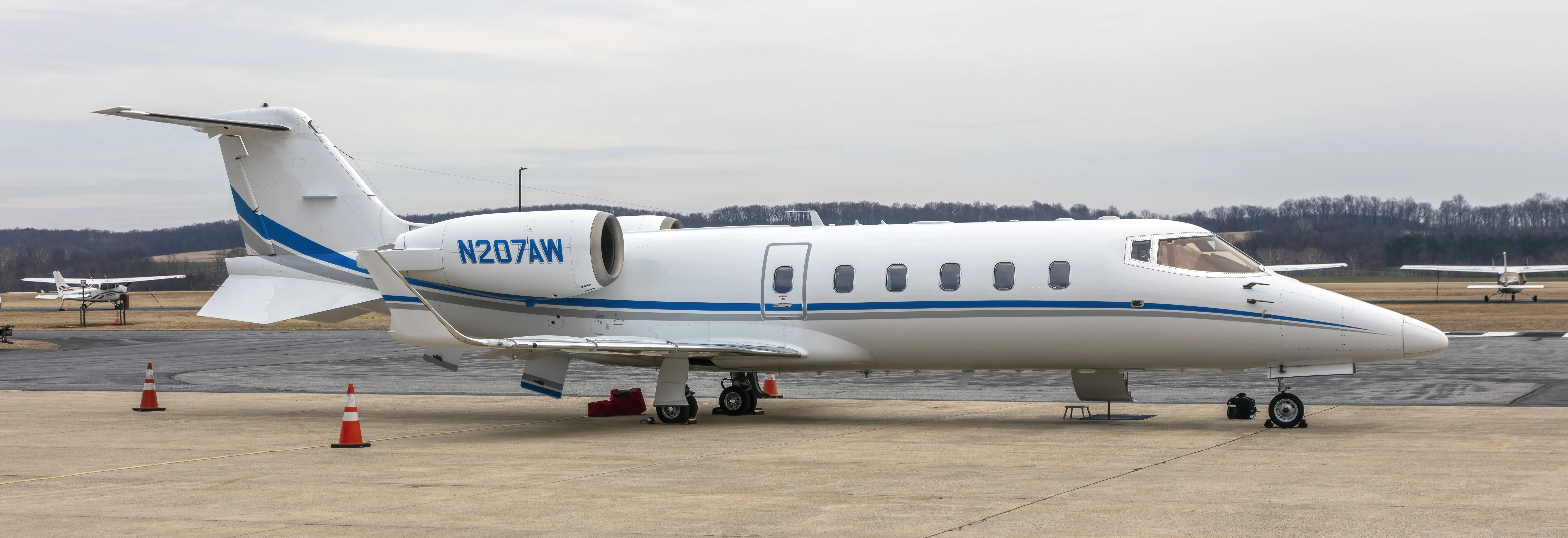 Learjet 60 N207AW parked on an airport apron