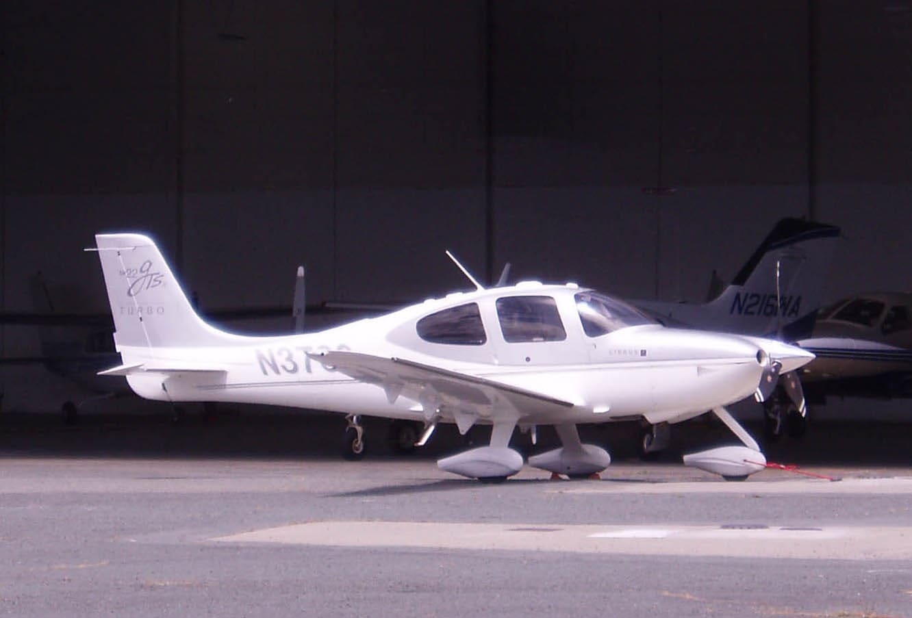 Cirrus SR22 parked at an open hangar