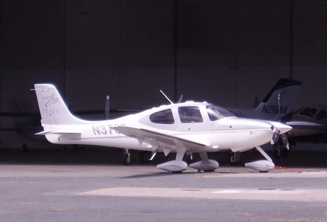 Cirrus SR22 parked at an open hangar